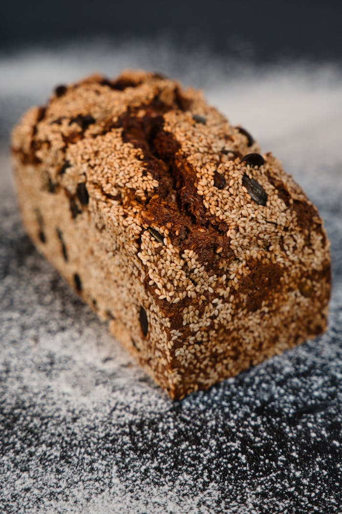 cta-02 Delicious artisan bread loaf made with seeds on a rustic surface.